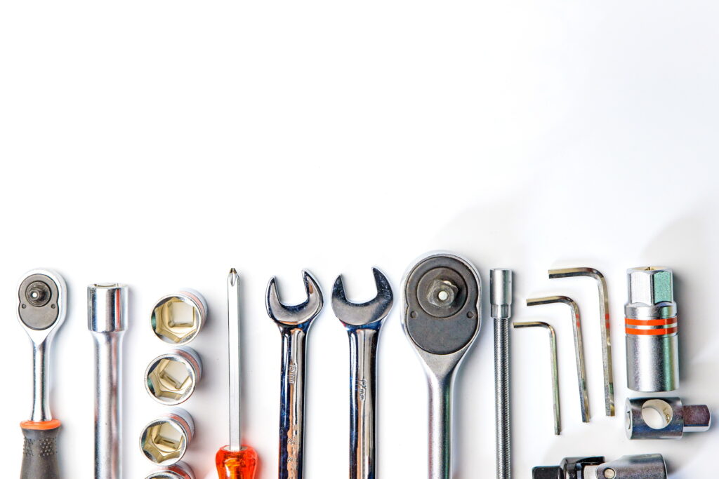 Top view of Working tools,wrench,socket wrench,hammer,screwdriver,plier,electric drill,tape measure,machinist square on white background. flat lay design.